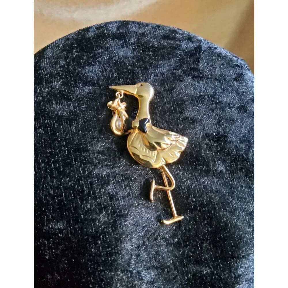 vintage gold tone/black bowtie stork with faux pearl dangling baby bundle brooch
